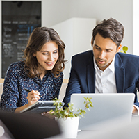 Business people looking at a laptop